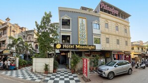 A hotel named 'Hotel Moonlight' with a checkered entrance, a signboard, and a parked car. - Hotel Moon Light  (Indore)