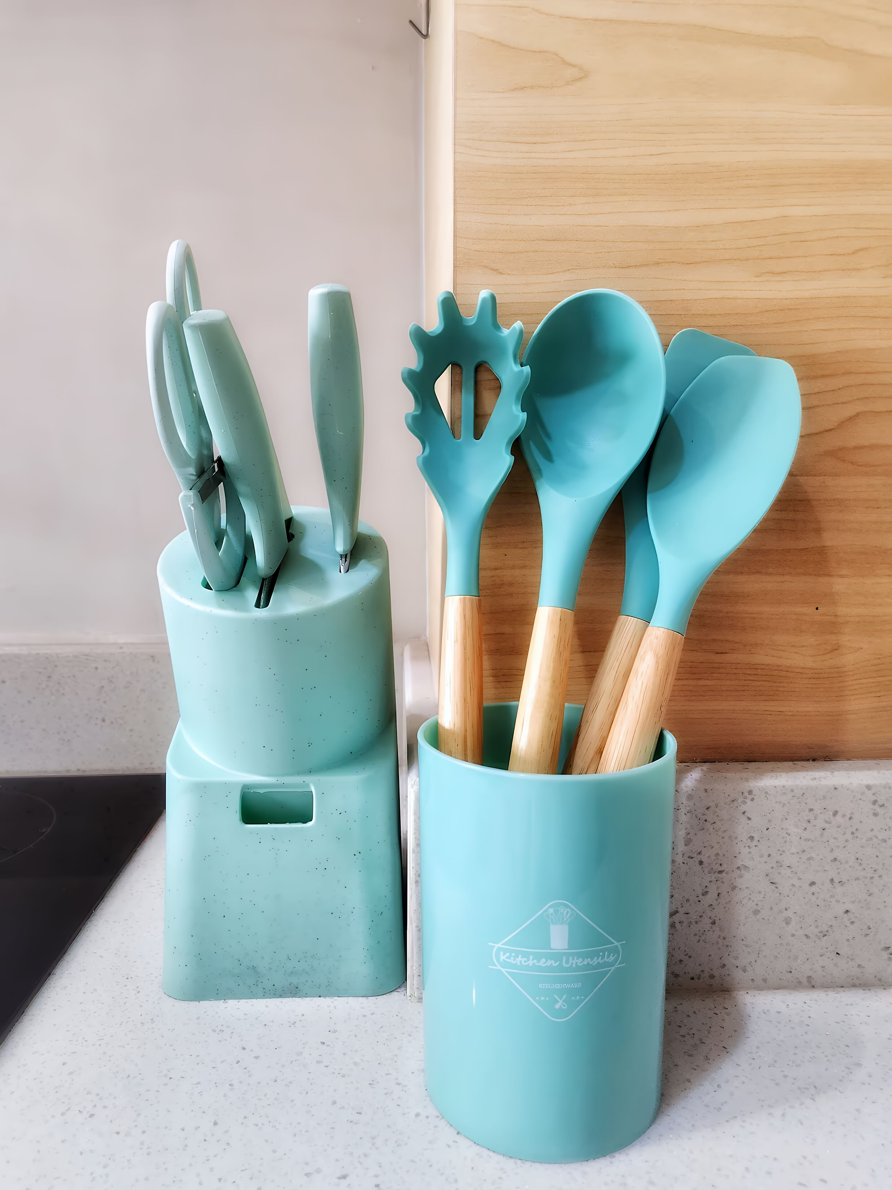 Two kitchen utensil holders with wooden utensils inside, placed on a kitchen counter.