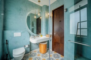 A bathroom with a white sink, a toilet, a mirror, and a shower area. - Vida Pacifica Villa (Verla Canca)