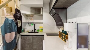 A modern kitchen with a built-in oven, a coffee machine, and a wine rack. - Shanghai Stylish Loft with 2B (Shanghai)