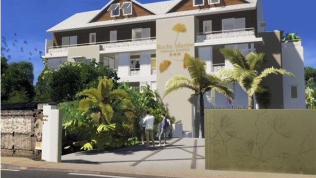 A two-story building with a sign reading 'Roche Marine.' - Roches Marines (Saint-Paul)