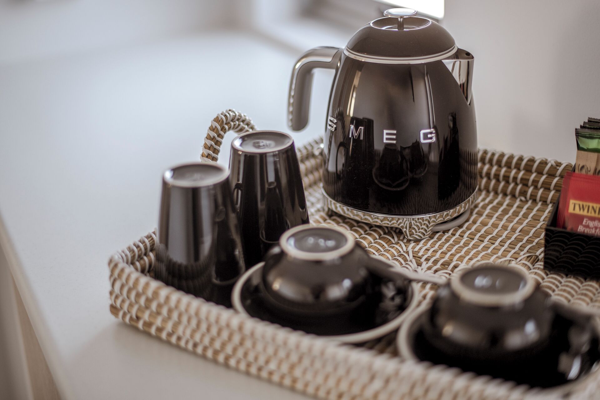 A tray with a coffee maker, cups, and a teapot.