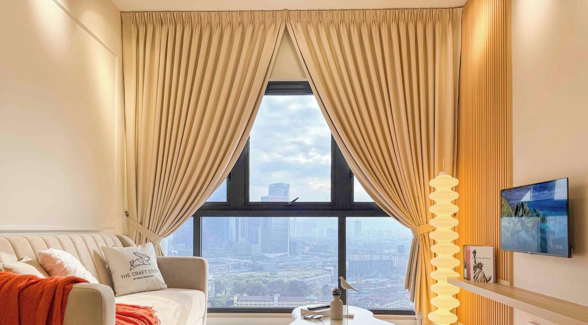 A modern living room with a city view, a sofa, a coffee table, and a lamp.