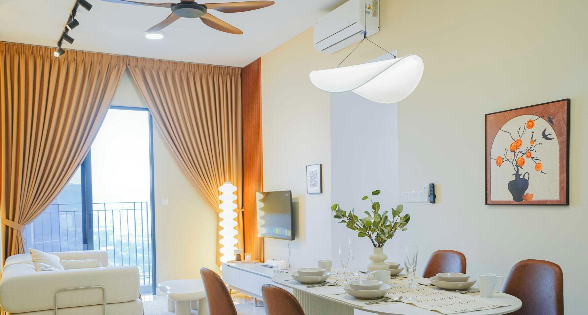A modern dining area with a long table, chairs, and a decorative vase.