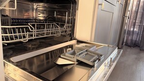A kitchen with stainless steel appliances, including a dishwasher and a stove.