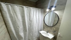 A bathroom with a shower curtain covered in mathematical equations, a sink, and a mirror. - Comfortable Retreat Near River Plate's Monumental Stadium (Buenos Aires)
