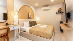 A modern hotel room with a bed, a desk, a chair, a TV, and an air conditioning unit. - Newly Renovated Pool Villa with BBQ V296 (Koh Samui)