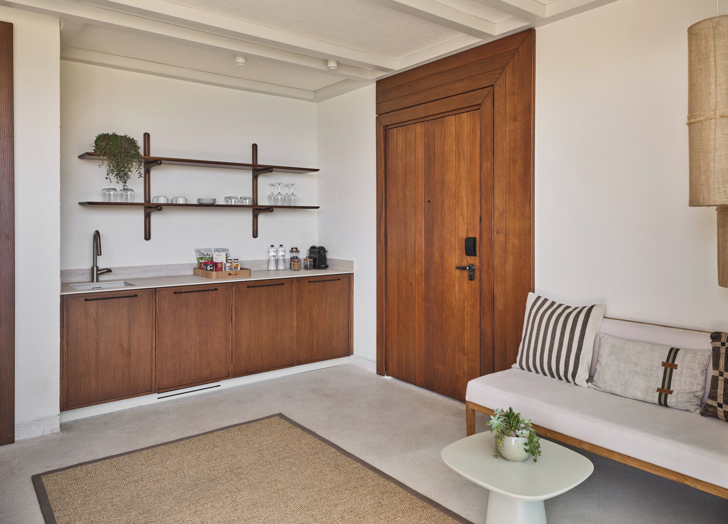 A modern kitchen with wooden cabinets, a built-in sink, and a countertop with various items.