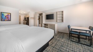 A hotel room with a large bed, a desk with a chair, a TV mounted on the wall, and a wardrobe. - MainStay Suites Harrisburg Airport - Hershey South (Middletown)