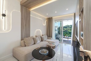 A modern living room with a sofa, a coffee table, and a TV. - THE SIGNATURE SUITE by DuHomes (Dubrovnik)