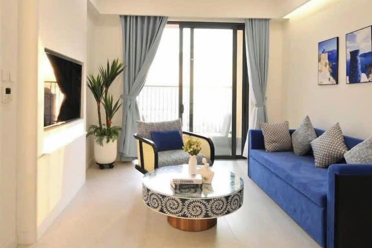 A modern living room with a sofa, armchair, and coffee table.