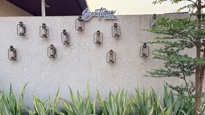 A wall with multiple lantern-style lights and a sign reading 'Boutique Stays'. - Boutique Stays Brissa by Greenleaf Aqua (Karjat)