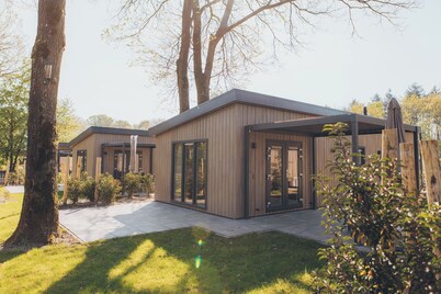 Stay in a luxurious holiday home for 4 people in the heart of the forested Veluwe, complete with modern amenities, air conditioning, a stylish pergola and a warm welcome for your pets.