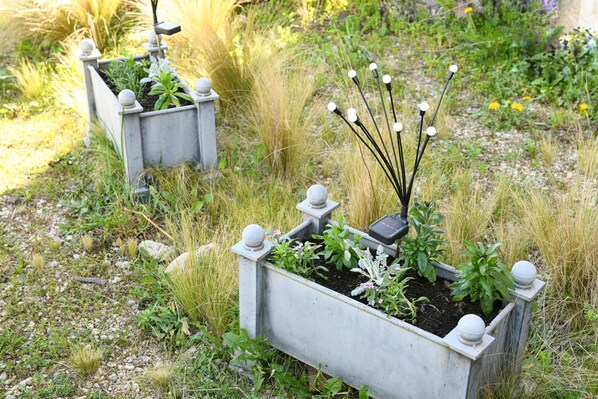 Garden planters with plants and decorative elements.
