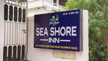 A Sea Shore Inn sign with contact details and location information.