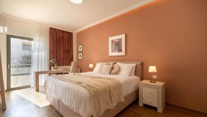 A bedroom with a bed, bedside tables, a desk, and a window with curtains. - Nikita 1 3rd·Signature Athenian Residence (Athens)