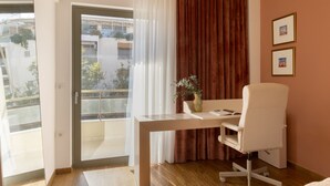 A hotel room with a desk, chair, and a view of the outside. - Nikita 1 3rd·Signature Athenian Residence (Athens)