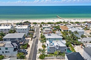 A coastal hotel with multiple buildings, a beach, and a pier. - Beach & Bay by Beach Boutique Rentals (Bradenton Beach)