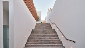A staircase with a handrail, leading up to a door at the top. - Extraordinary Villa With Private Pool & Steamsauna (Mellieha)