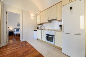 A modern kitchen with white cabinets, a built-in oven, a microwave, and a refrigerator. - M (TOL241) Spectacular 2 bedroom apartment in the Plaza Mayor (Madrid)
