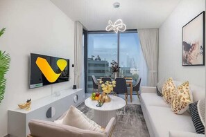 Luxury Apartment, City View | Living area | 65-inch Smart TV with cable channels - Vogue | Sobha Hartland close to Downtown Dubai Mall | Burj Khalifa (Dubai)
