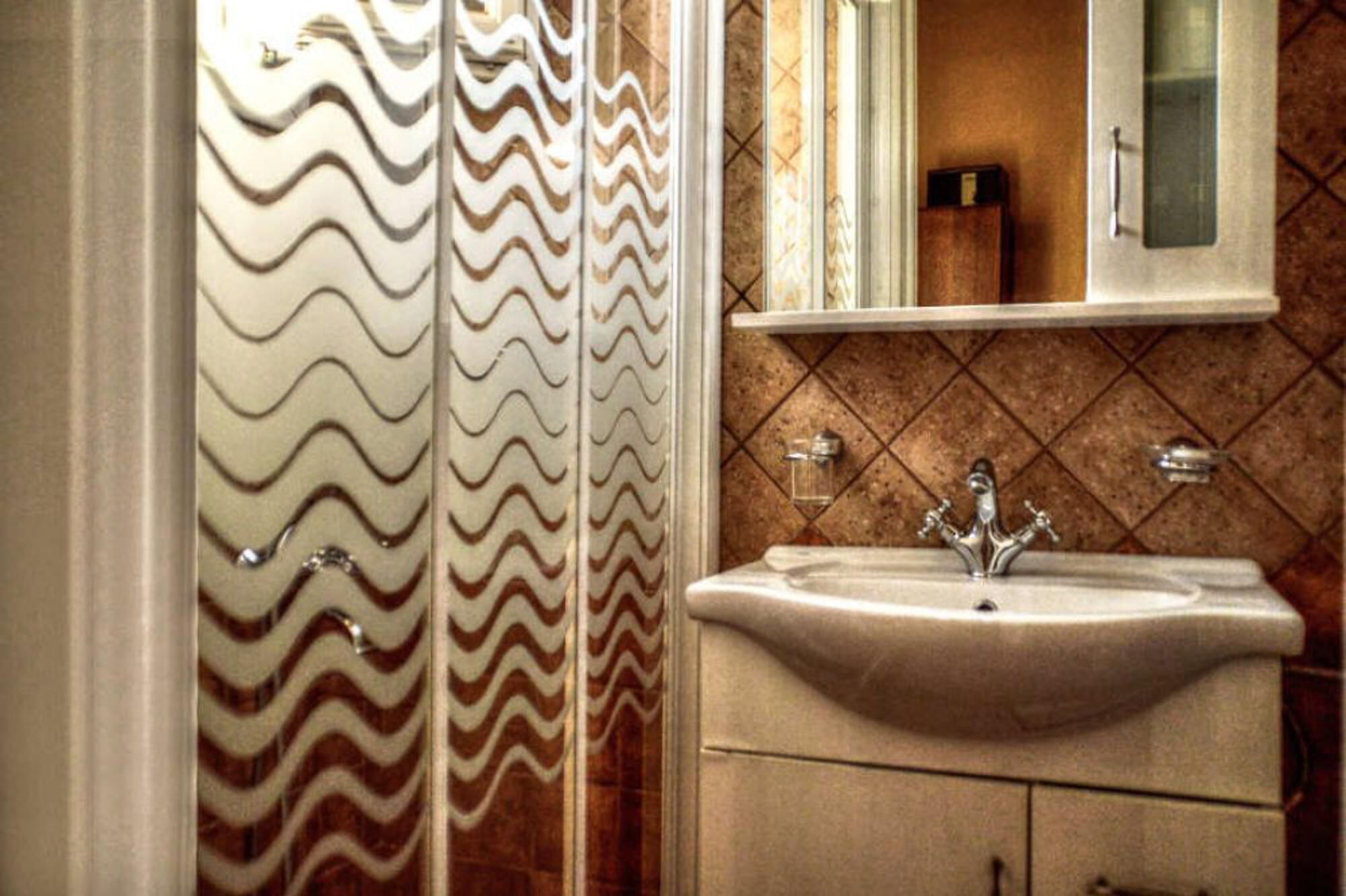 A bathroom with a sink, vanity, and a mirror.