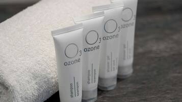 Four tubes of 3 ozone shampoo and shower gel on a textured surface.