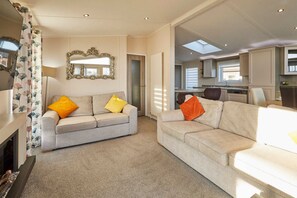 A spacious living area with two sofas, a fireplace, and a large mirror. - Host Stay Penny Lodge (York)