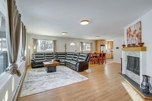 A modern living room with a sectional sofa, a coffee table, and a fireplace. - Walkable Adventure Base in Midtown Anchorage (Anchorage)