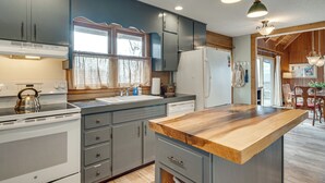 A kitchen with a wooden countertop, white appliances, and grey cabinets. - 'point of View' Hilltop Sanctuary in Brevard (Brevard)