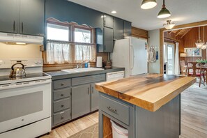 A kitchen with a wooden countertop, white appliances, and grey cabinets. - 'point of View' Hilltop Sanctuary in Brevard (Brevard)