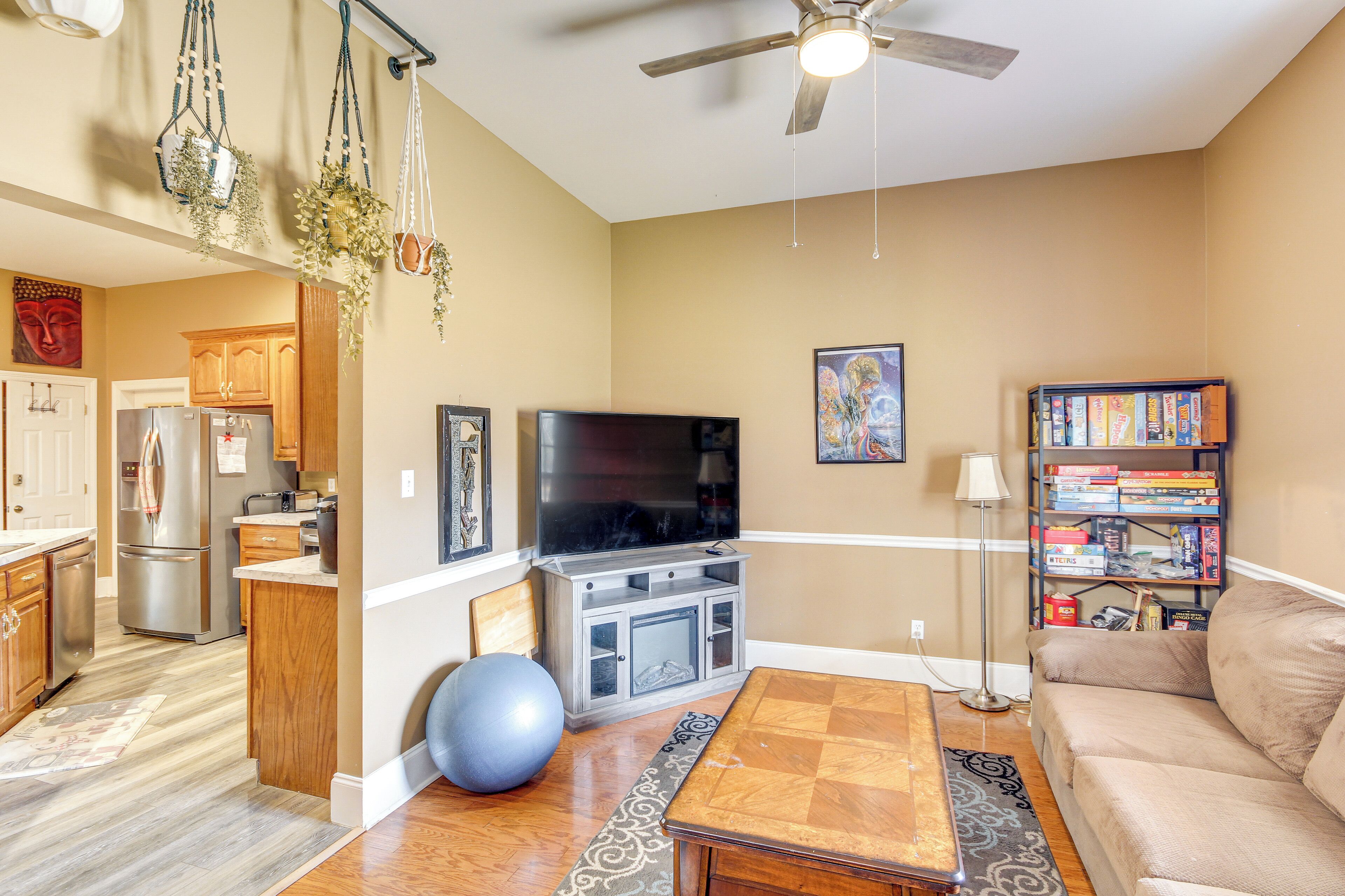 A living room with a TV, sofa, and bookshelf.