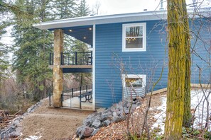 A two-story house with a stone pillar, a covered deck, and a small window. - Covered Patio, Creek & Mtn Views: Afton Nature Hub (Afton)