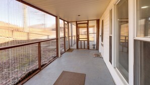 A covered balcony with a view of a field, a door leading inside, and a window on the right. - 4 Mi to Gauley River Rapids! Outdoor Adventure Hub (Summersville)