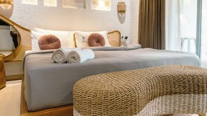 A neatly made bed with pillows, a rolled towel, and a woven chair. - Hidden Beach Resort by Greenleaf Aqua (Karjat)