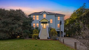 A two-story house with a front porch and a driveway. - Golf & Surf 7BR: Private Pool, 5 Min to Beach (Corolla)