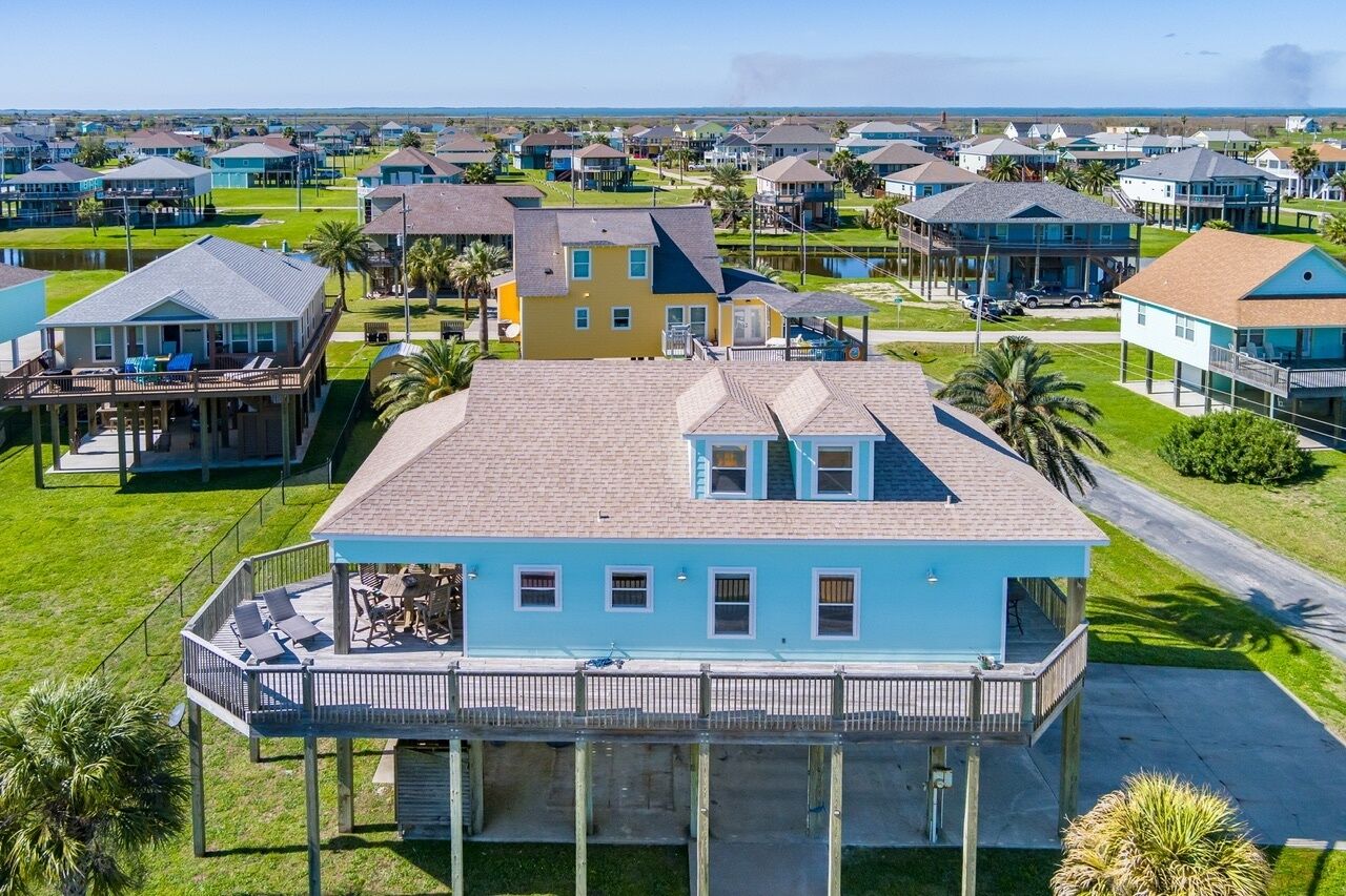 A coastal residential area with houses featuring balconies and waterfront views.