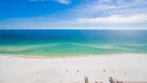 A beach with clear turquoise waters and a sandy shore. - Phoenix Gulf Shores Ii 1904 3 Bedroom Condo (Gulf Shores)
