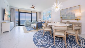 A modern hotel room with a dining area, large windows, and artwork on the walls. - Phoenix Gulf Shores Ii 1904 3 Bedroom Condo (Gulf Shores)