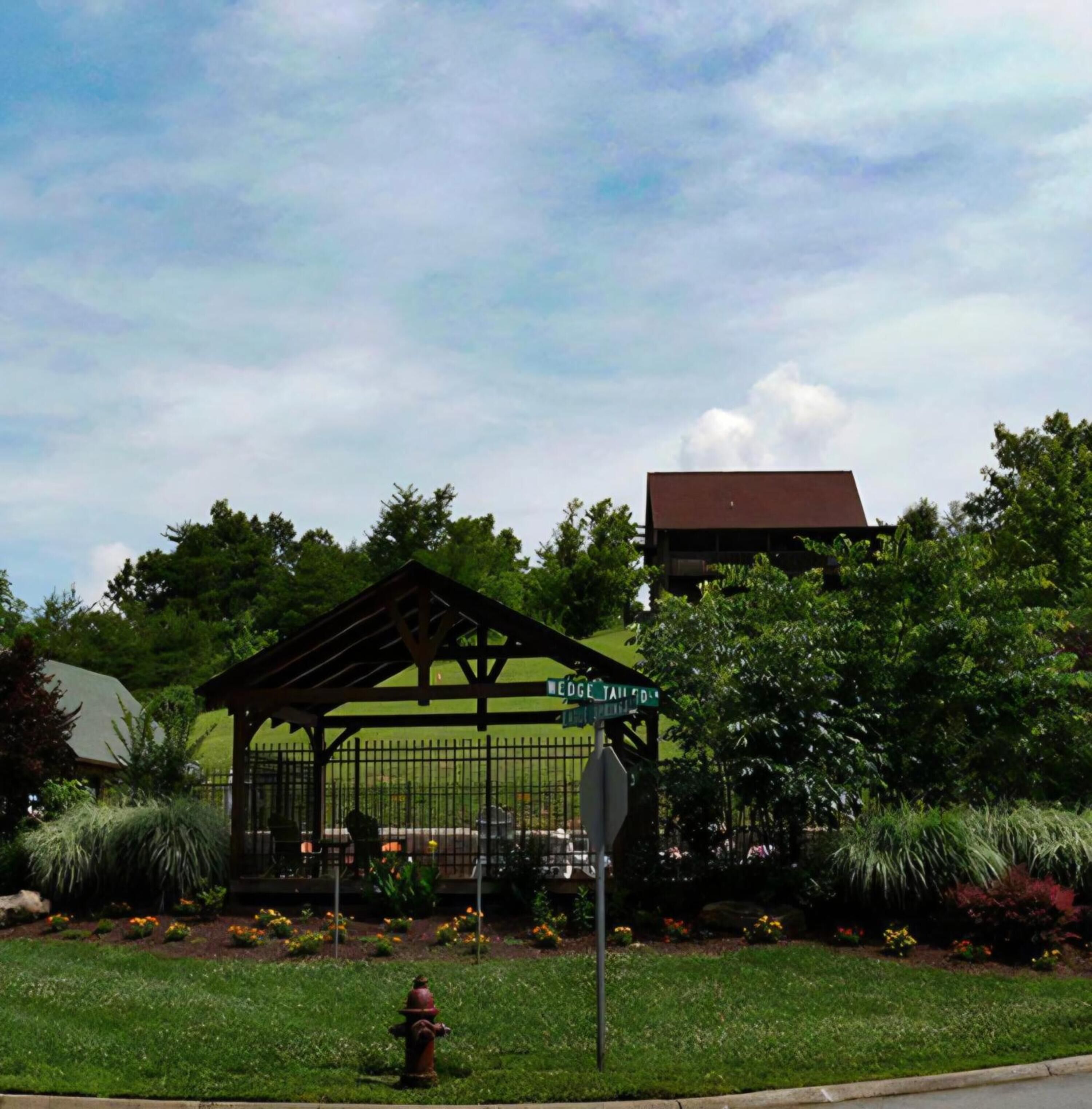 A gazebo with a metal roof and a stop sign nearby.