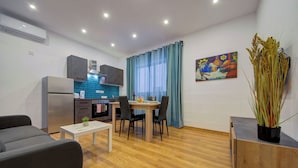 A modern apartment with a kitchen, dining area, and living room. - Charming Sliema Apartment Off the Ferries Seafront (Sliema)