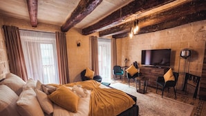 A bedroom with a bed, a desk, a chair, a television, and a large window. - Palazzino Valentina Valletta (Valletta)