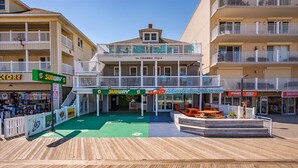 A beachfront building with a Subway entrance, a pool area, and various shops. - Columbus Villa 107 - 3 bedroom on the boardwalk with great beach and ocean views~ (Ocean City)