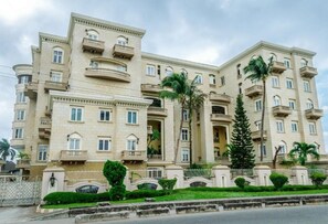 A multi-story hotel with balconies, a gated entrance, and well-maintained landscaping. - Clayhall By SRS (Lagos)