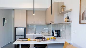 Cozinha moderna com ilha central, banquetas e iluminação pendente.