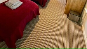 A small, cozy room with two beds, a wooden wardrobe, and a skylight. - Elliot Cottage Your Retreat in Heart of Peebles (Scottish Borders)