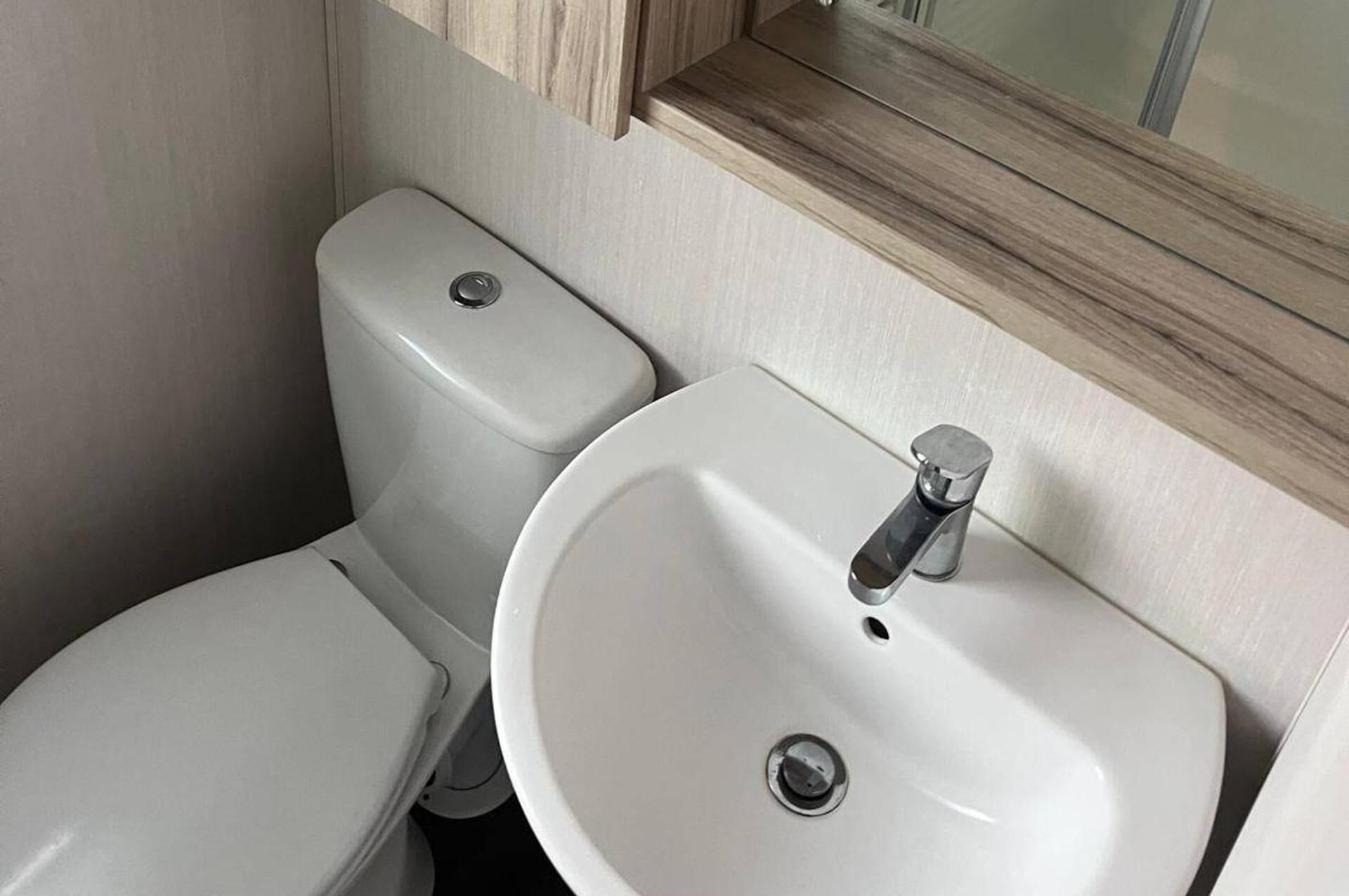 A small bathroom with a toilet and a sink.