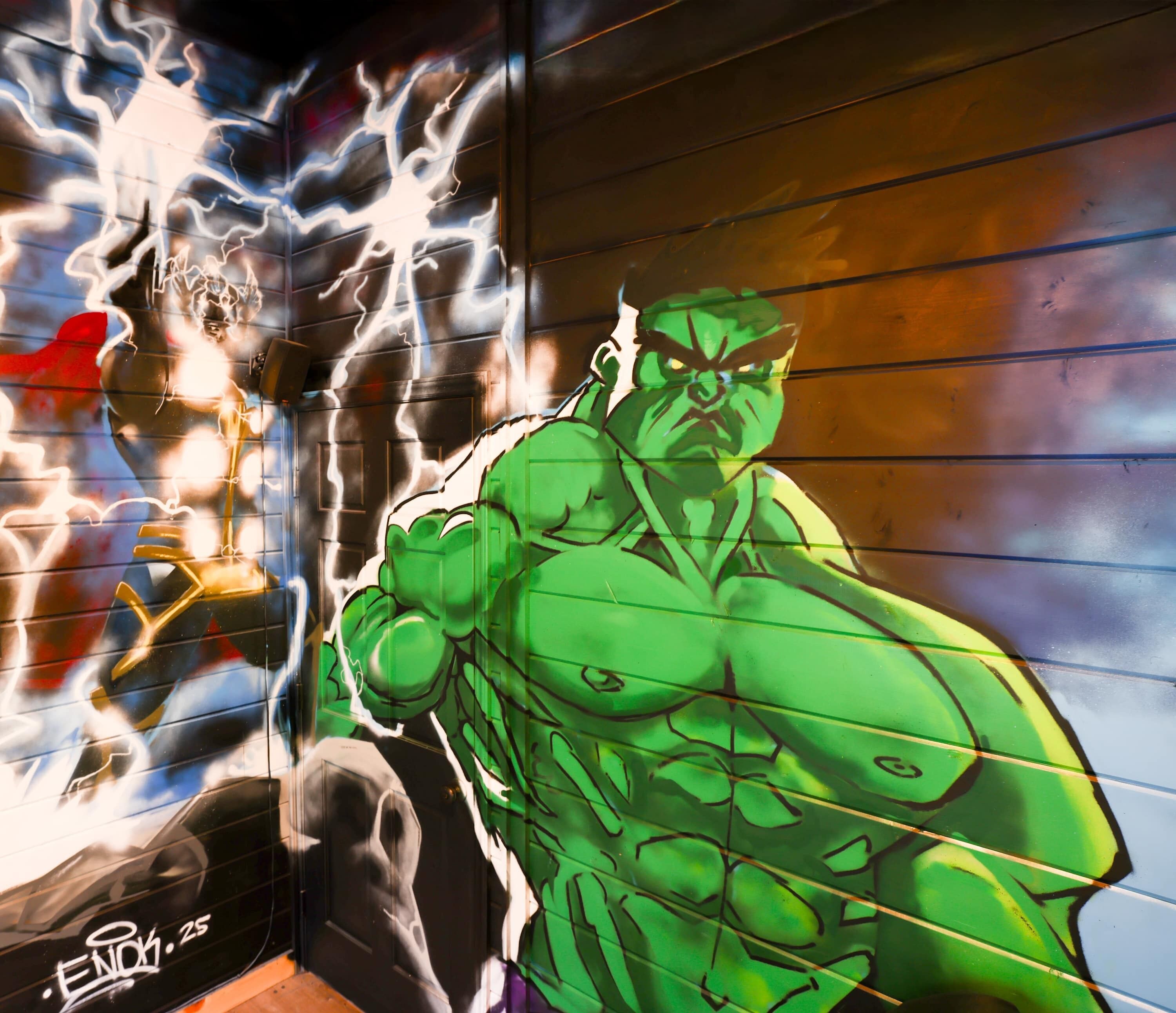 A mural of a muscular green character on a wall.