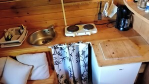 A compact kitchen with a sink, two electric kettles, a coffee maker, and a small countertop. - Col de la Faucille Tonneau (Mijoux)