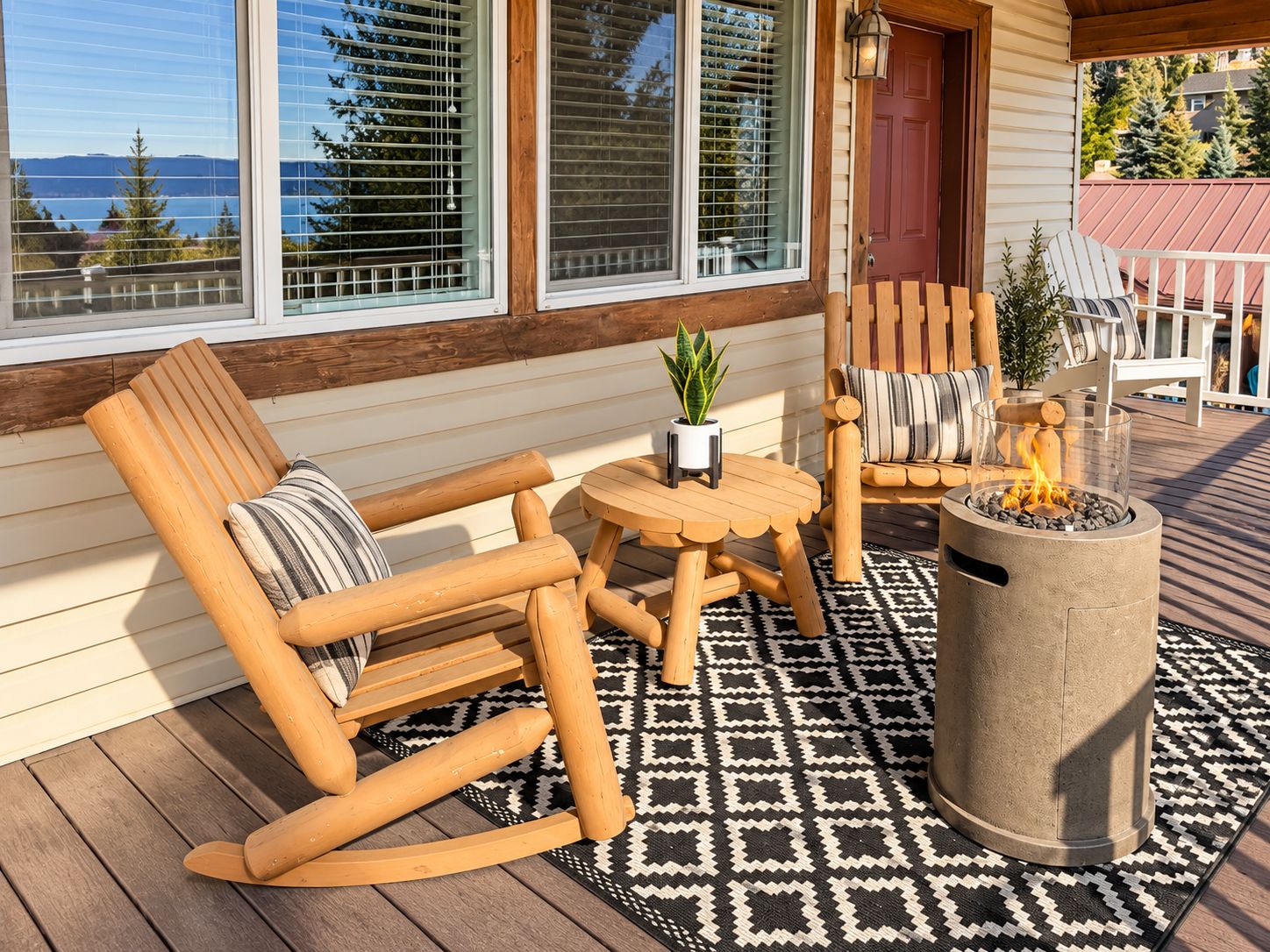 A wooden deck with a rocking chair, a small table with a plant, and a fire pit.